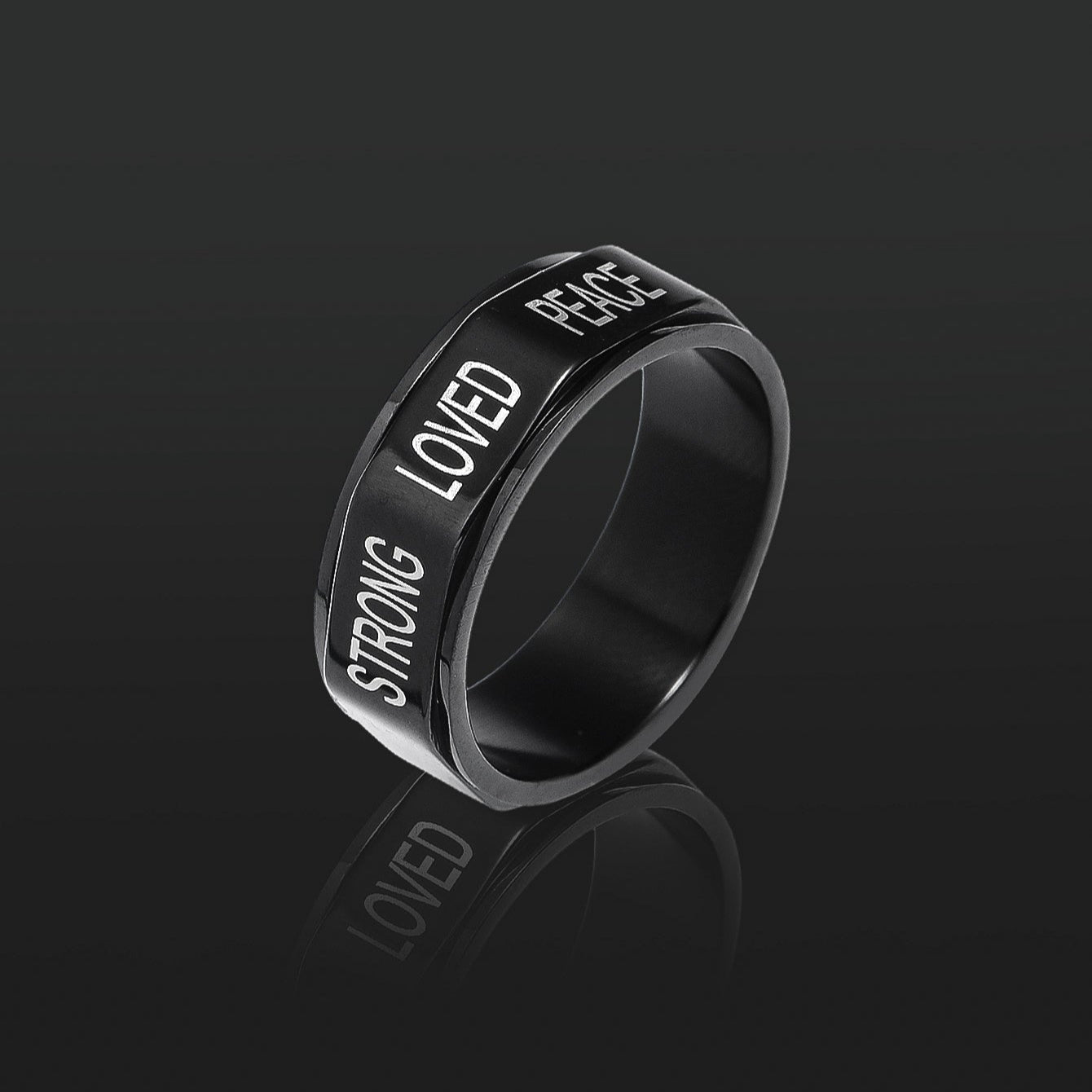 This black encouragement spinner ring in the dark
