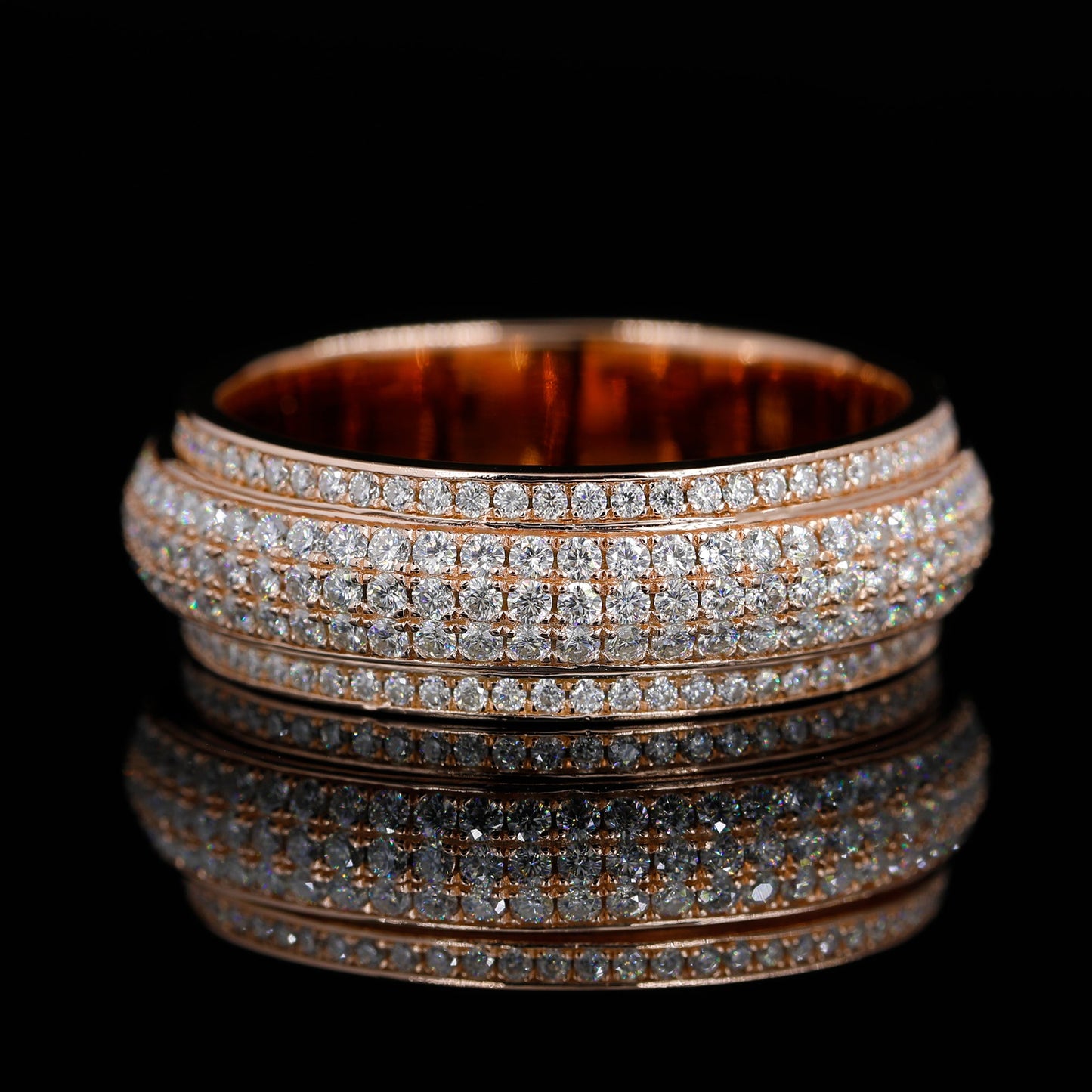 Flat Lay of Iced Out Moissanite Spinner Ring(Rose Gold finish) on Black Background