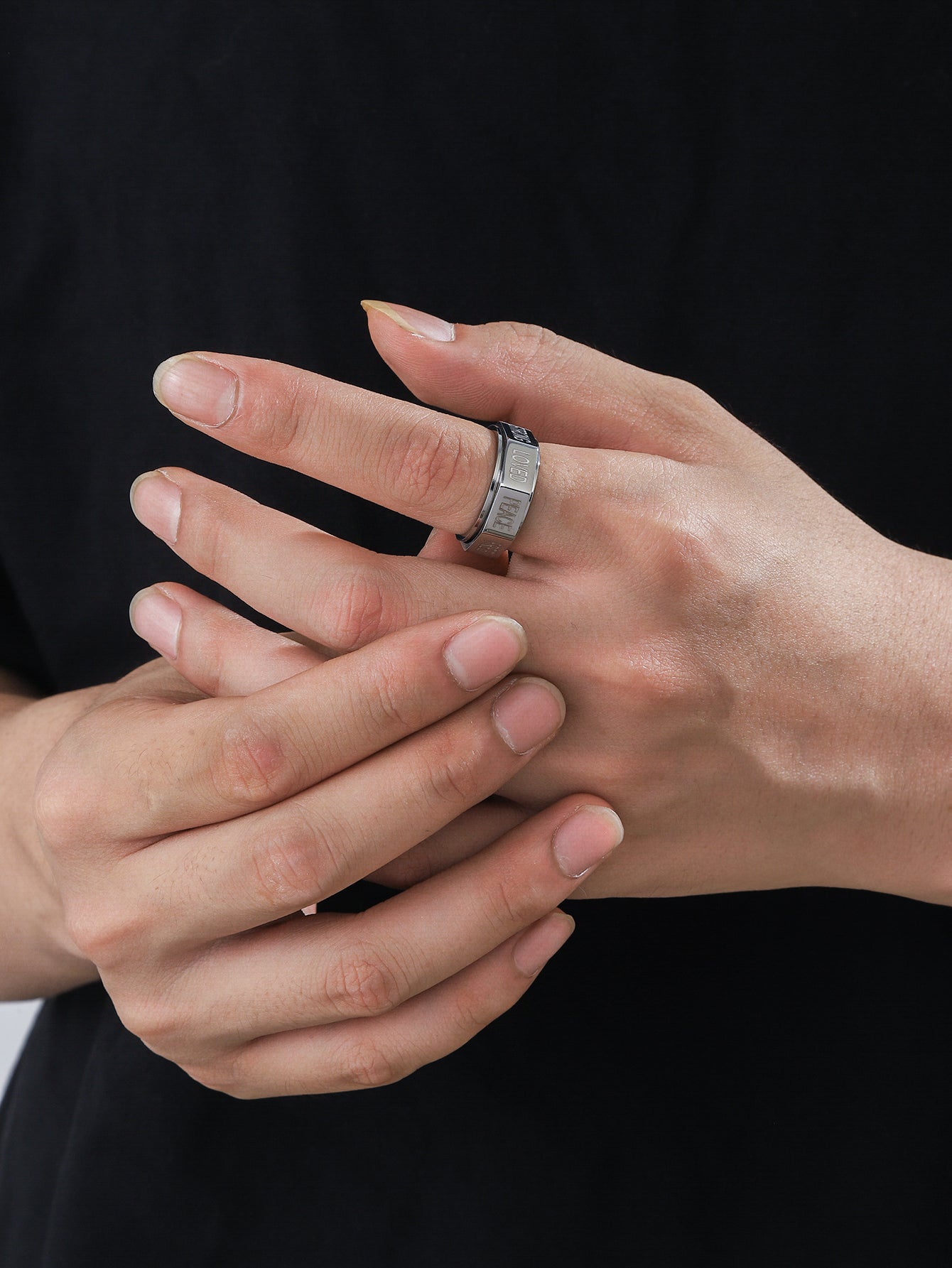 A man wearing this silver  positive words spinner ring