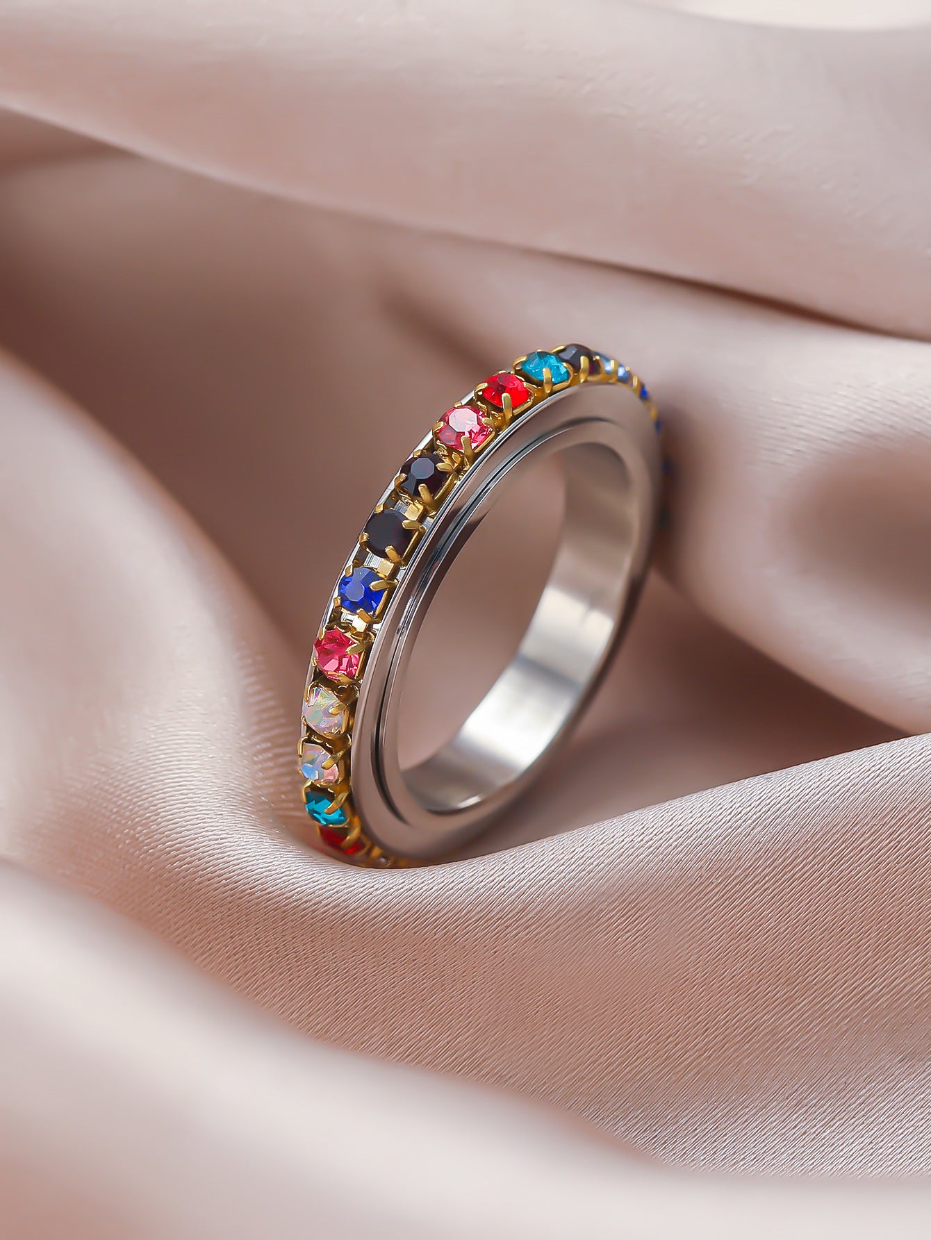7Chakra/Rainbow Spinner Ring laid on the velvet - perfect gift for women