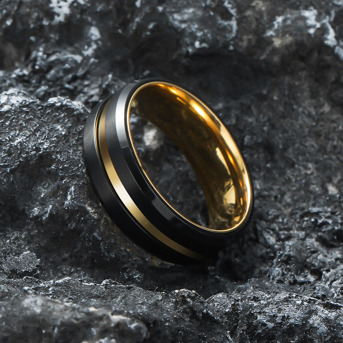 Close-up of Black Gold Double Spinner Fidget Ring placed on natural rock  – Calmfor stress relief jewelry