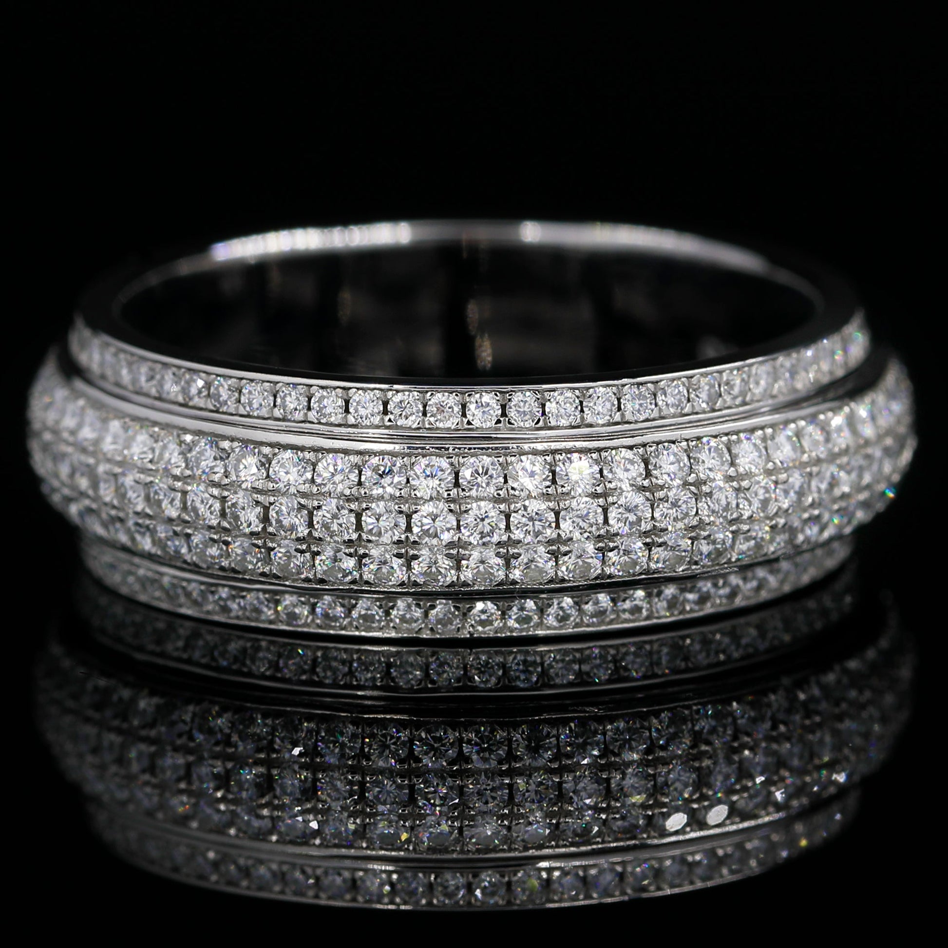 Flat Lay of Iced Out Moissanite Spinner Ring(White Gold finish) on Black Background 