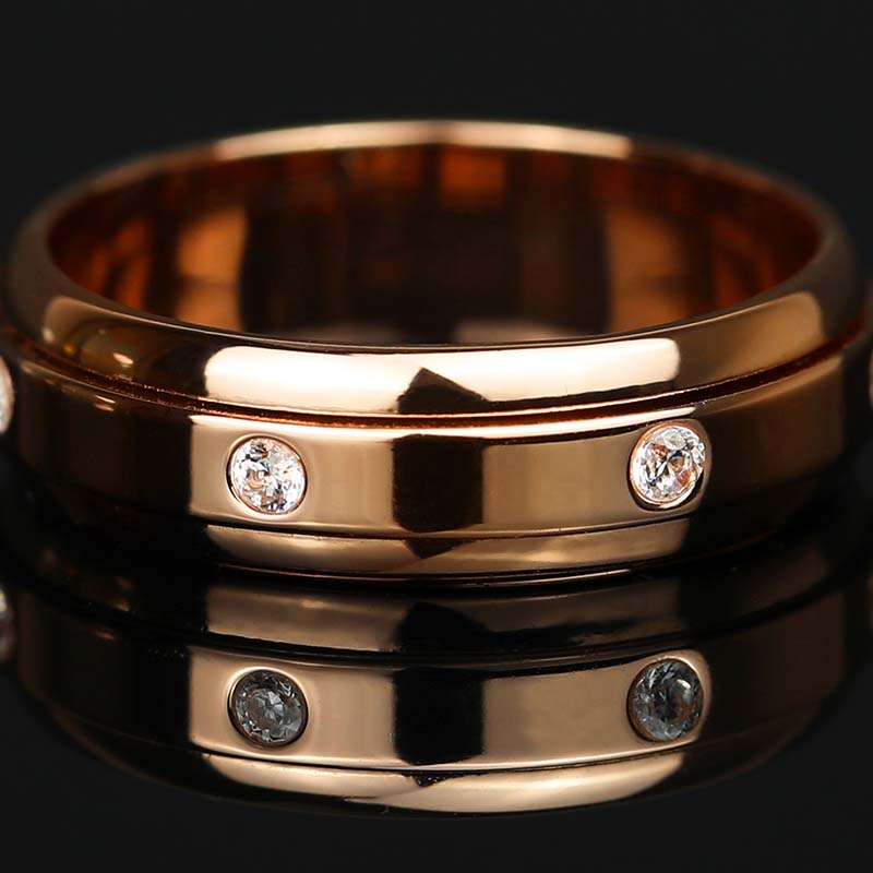 Flat lay of 7 Moissanite Stones Spinner Fidget Ring in Rose Gold Finish 