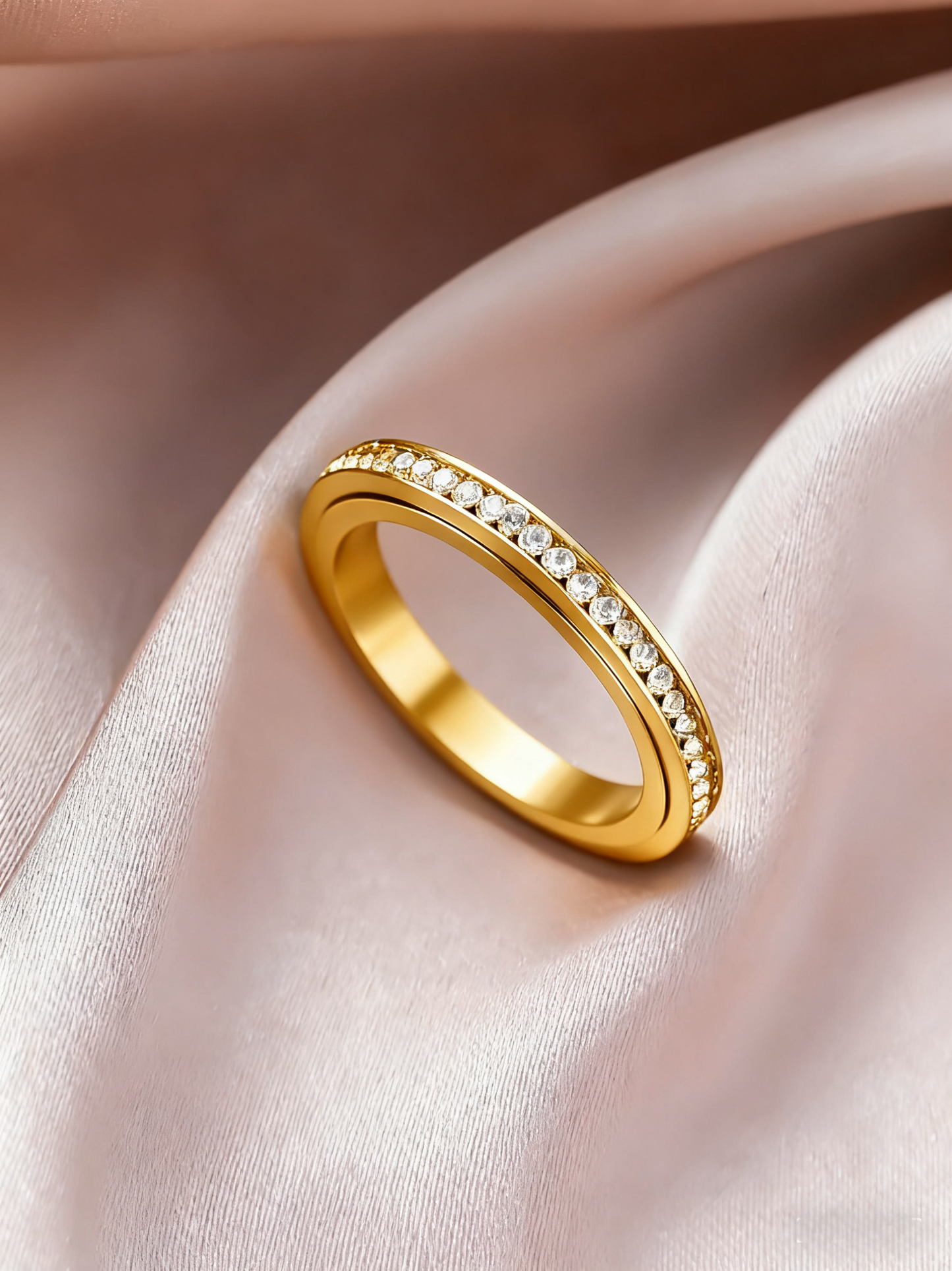 Iced_Out_slim_ring_in_Gold_laying_on_the_velvet