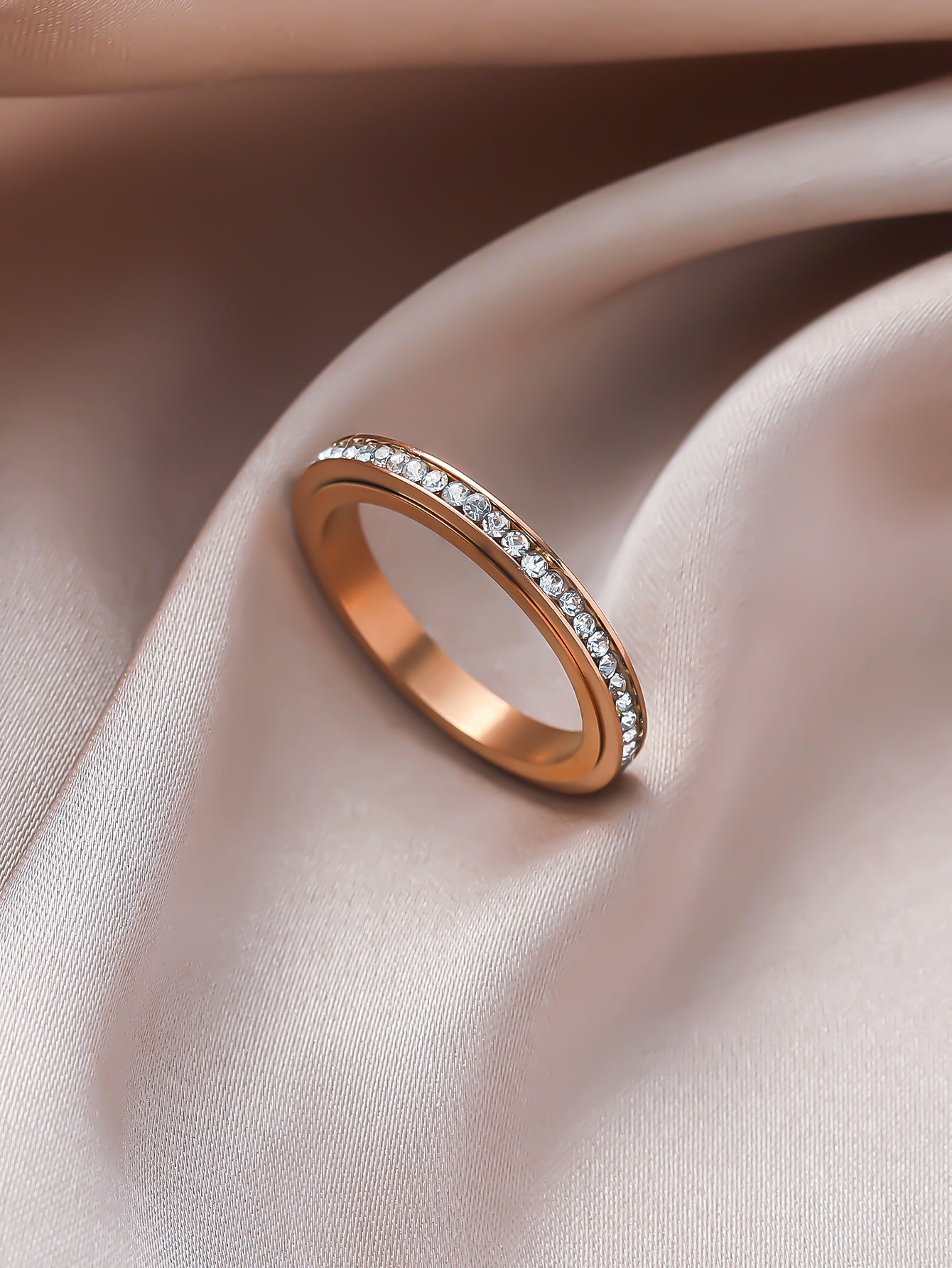 Iced_Out_slim_ring_in_RG_laying_on_the_velvet